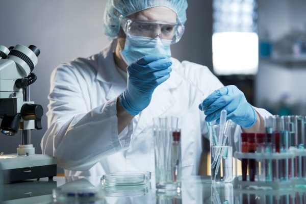 Laboratory worker measuring exact formula for hypoallergenic cosmetic products